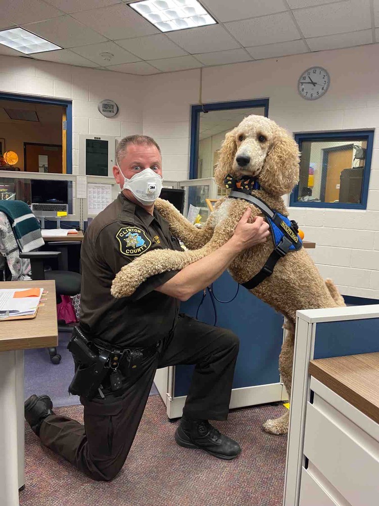 Sandee demonstrates the "cuddle" command for Officer Vance from Clinton County.